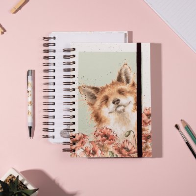 Fox illustration in a poppy field on a notebook