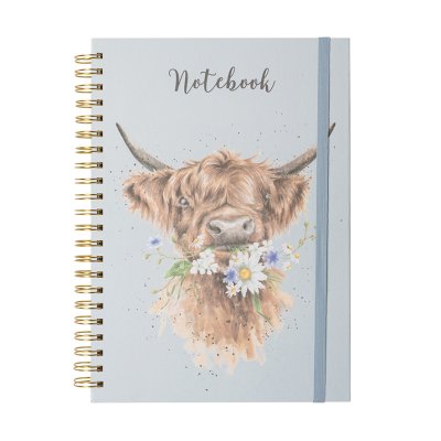 A highland cow chewing a mouthful of flowers on an A4 spiral bound notebook