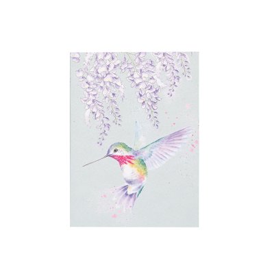 A colourful hummingbird flying on an A6 paperback notebook